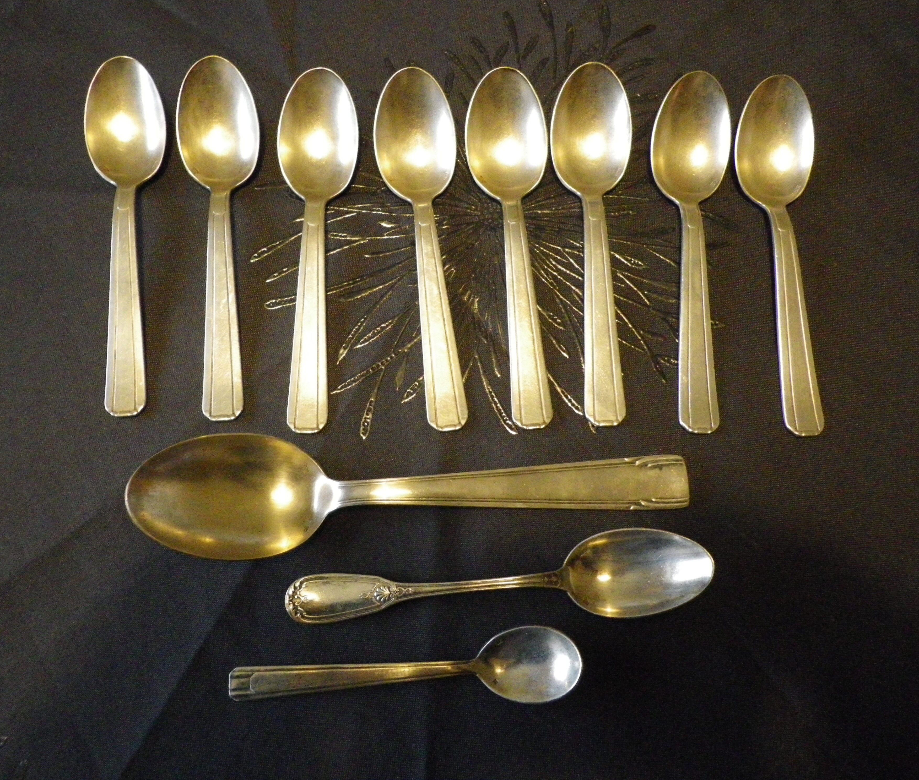 11 silver spoons with punches