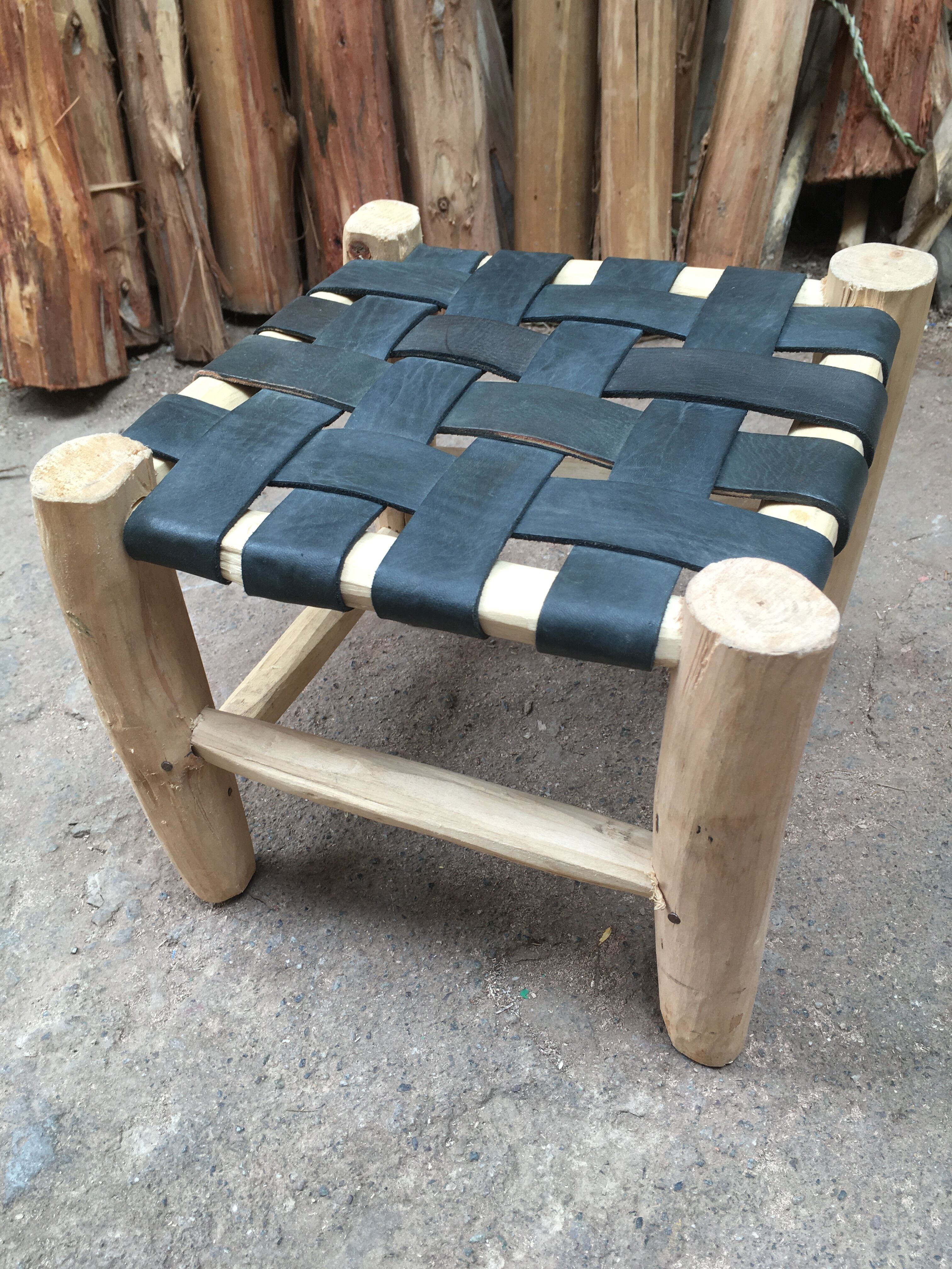 Set of four traditional moroccan stools in black leather and raw wood