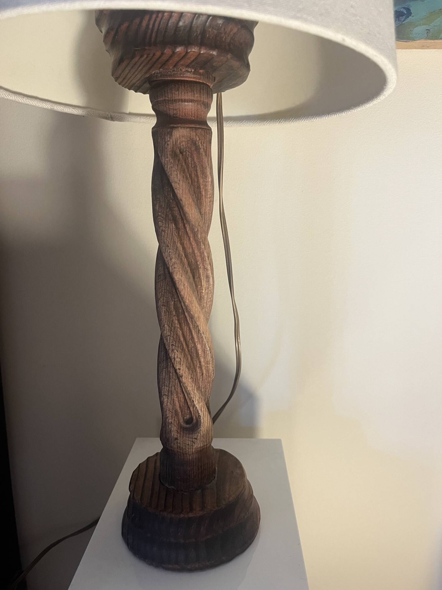 Wooden floor lamp with white tweed shade.
