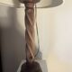 Wooden floor lamp with white tweed shade.