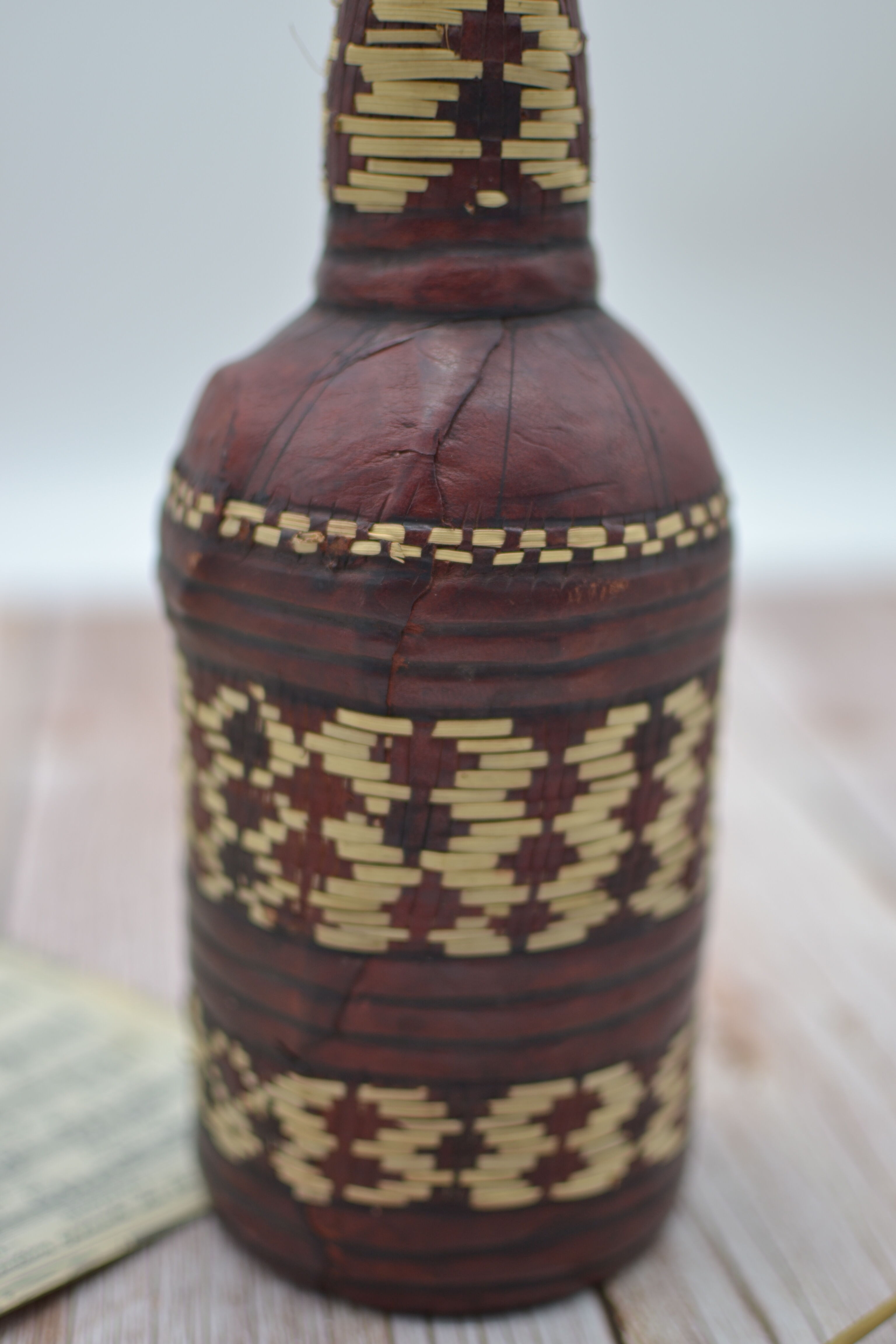 Set of 2 decorative vintage bottles covered with leather & wicker