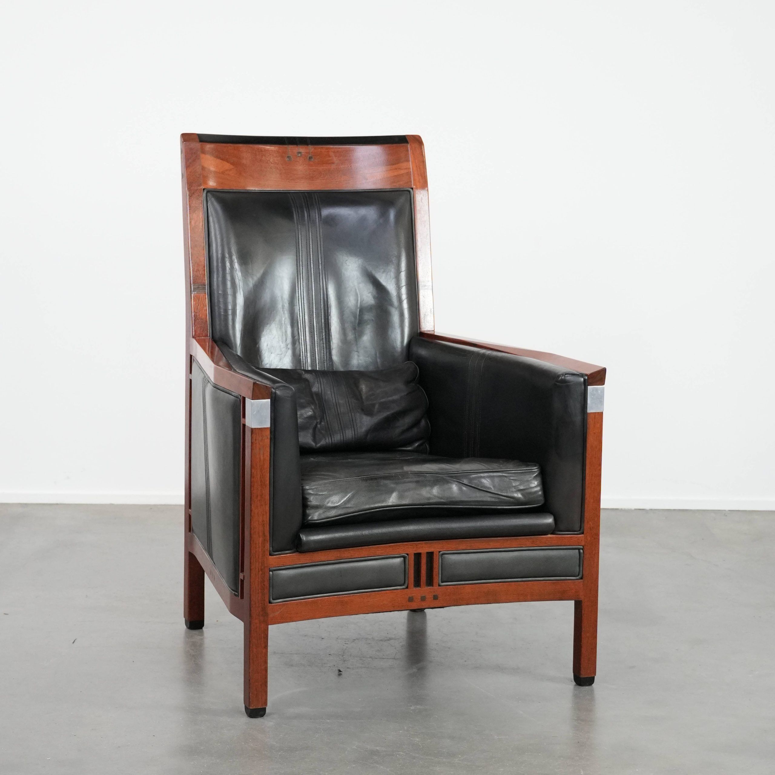 Black cowhide leather and wooden Art Deco design armchair