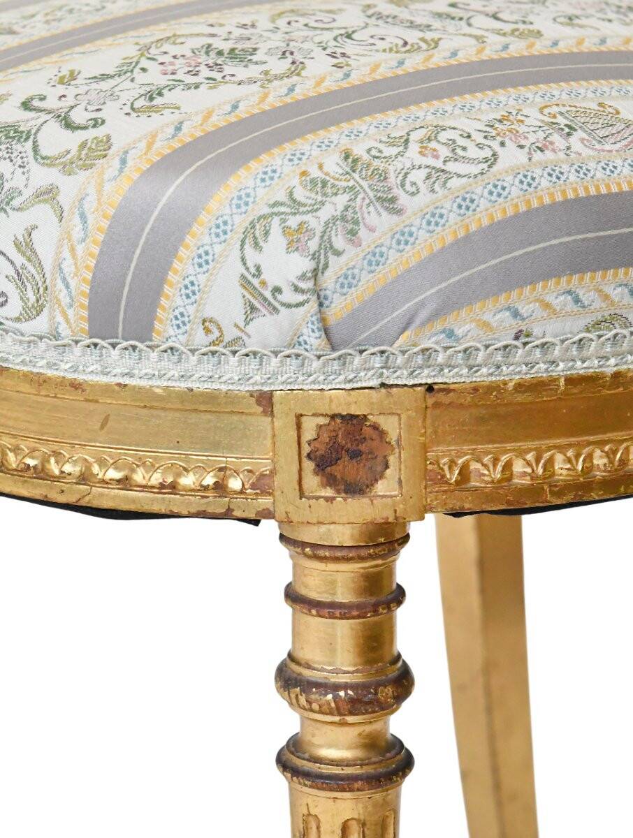 Pair of Louis XVI style chairs in gilded wood.