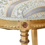 Pair of Louis XVI style chairs in gilded wood.