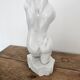 Sculpture of a female torso in white marble.