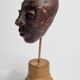 Expressive sculpted head in patinated terracotta on wooden base, 14 cm