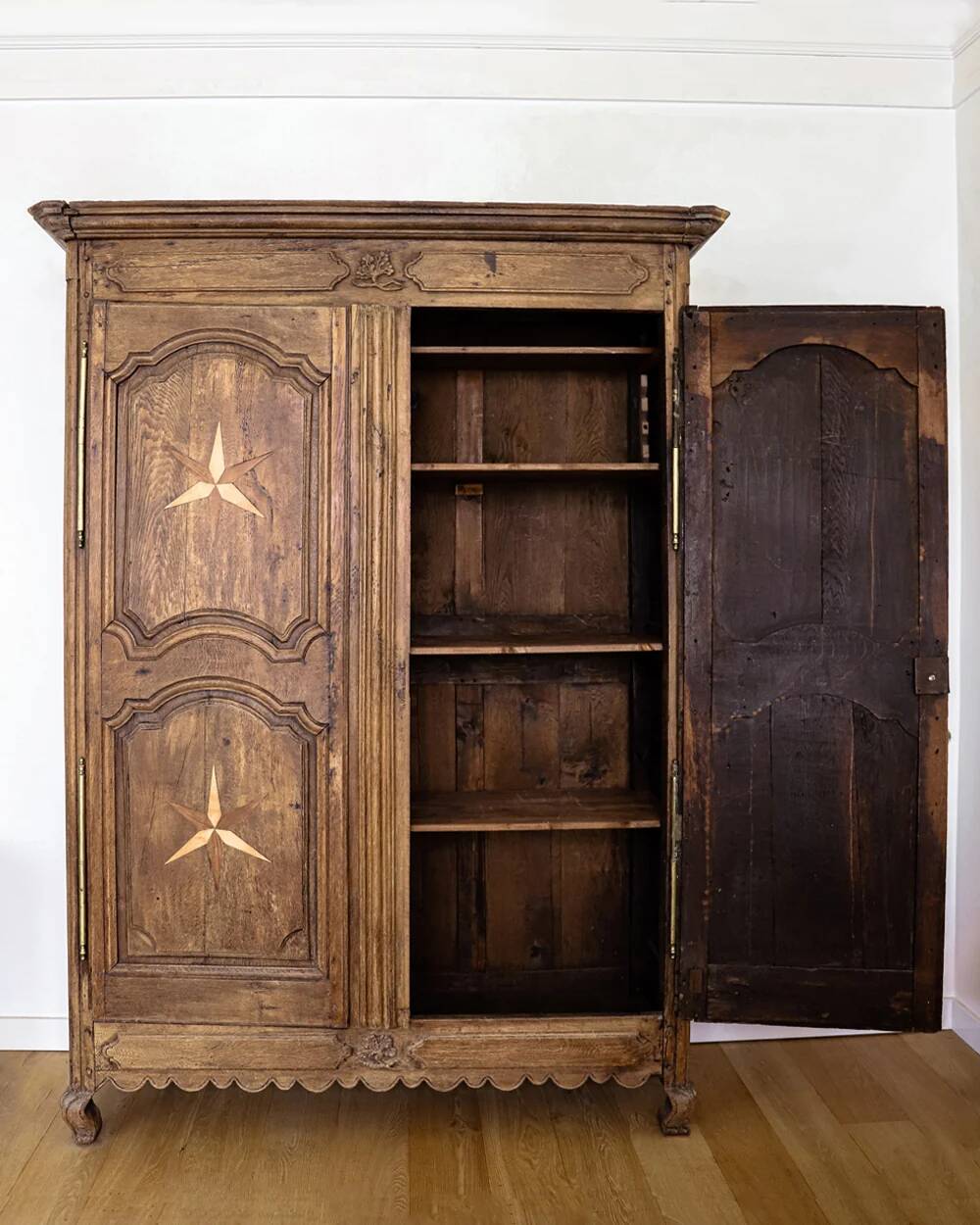 Antique French rustic wardrobe with star inlays.