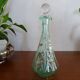 Old carafe enamelled with glass flowers