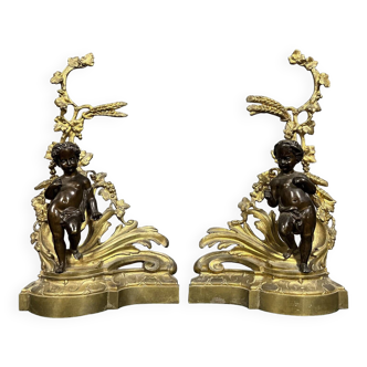 Pair of gilded bronze and patinated bronze andirons depicting putti circa 1850
