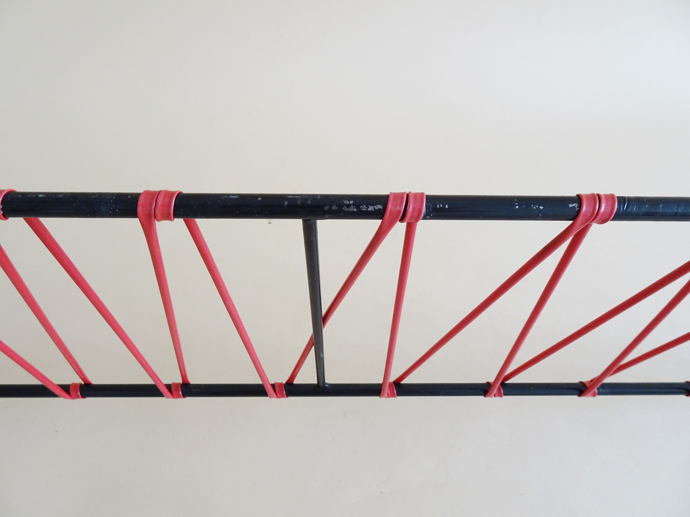Minimalist wall coat rack in string design in black and red