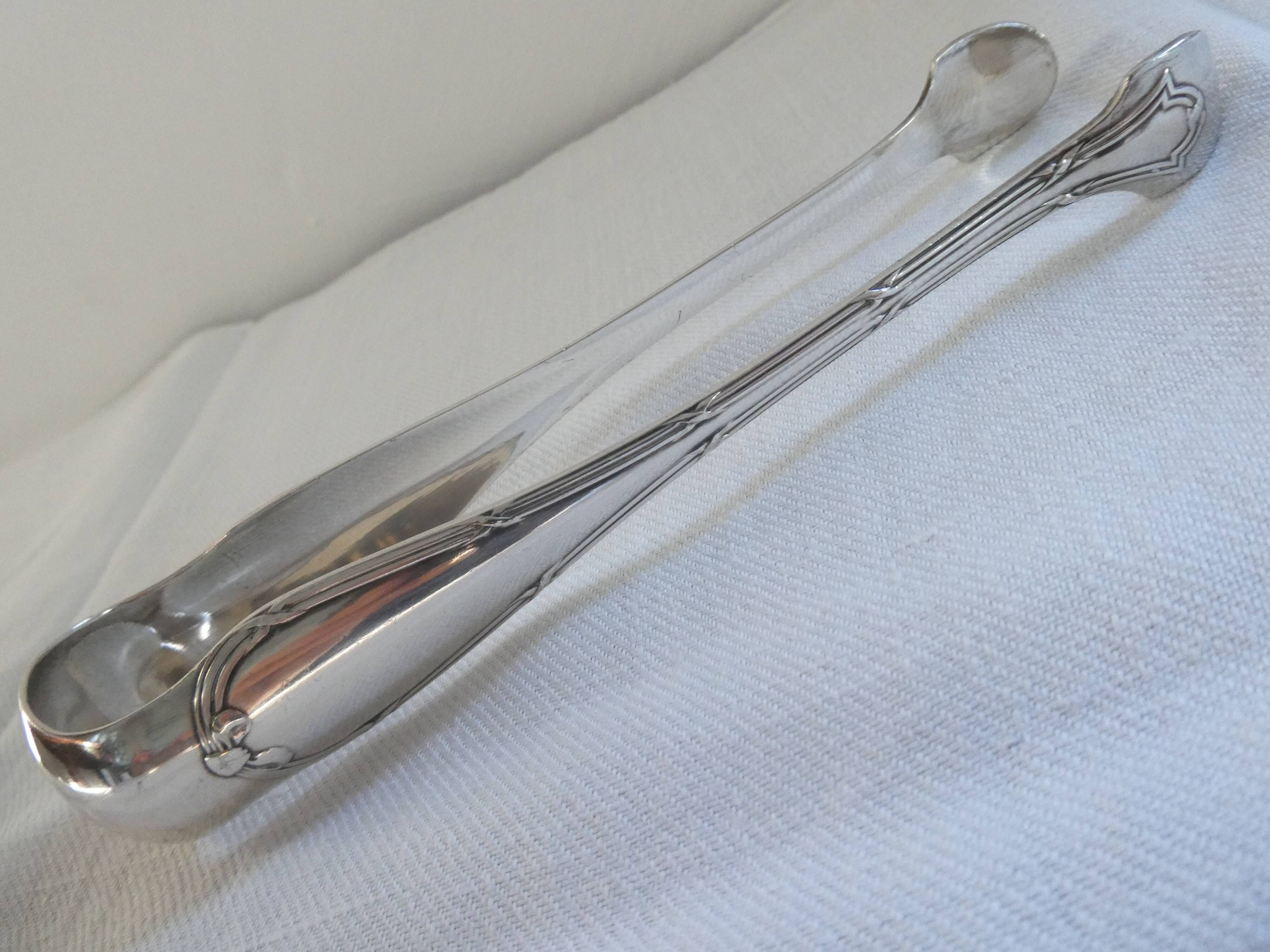 Christofle Silver-plated metal sugar tongs with crossed ribbon bow design