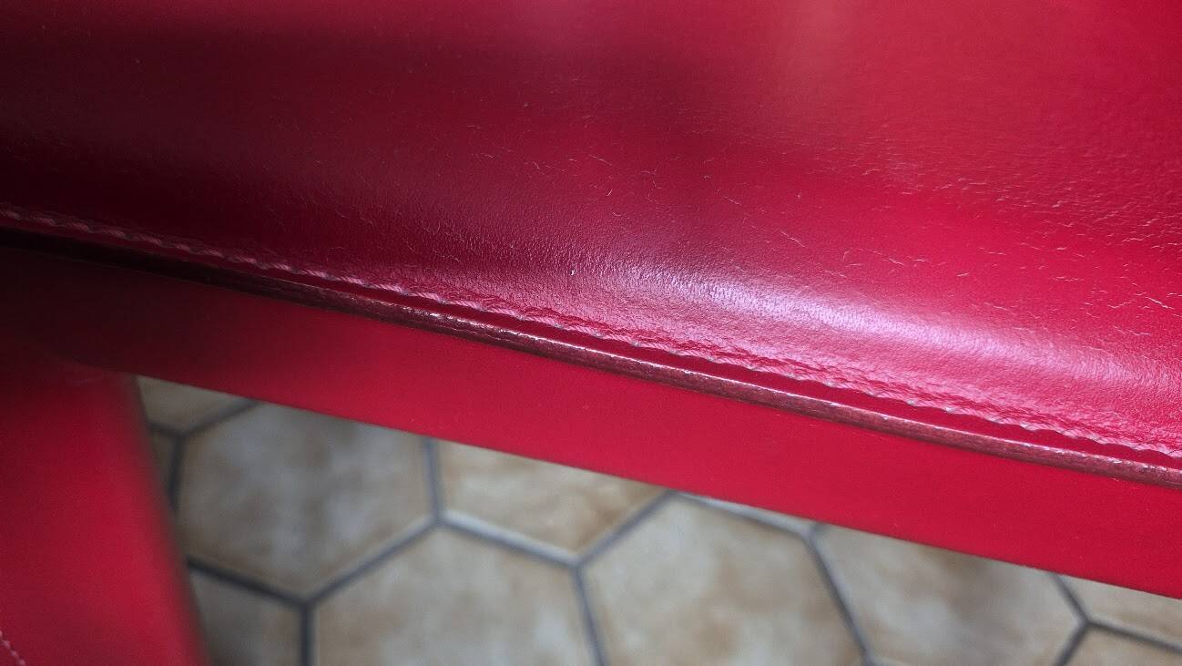 Red leather dining chairs by Arper