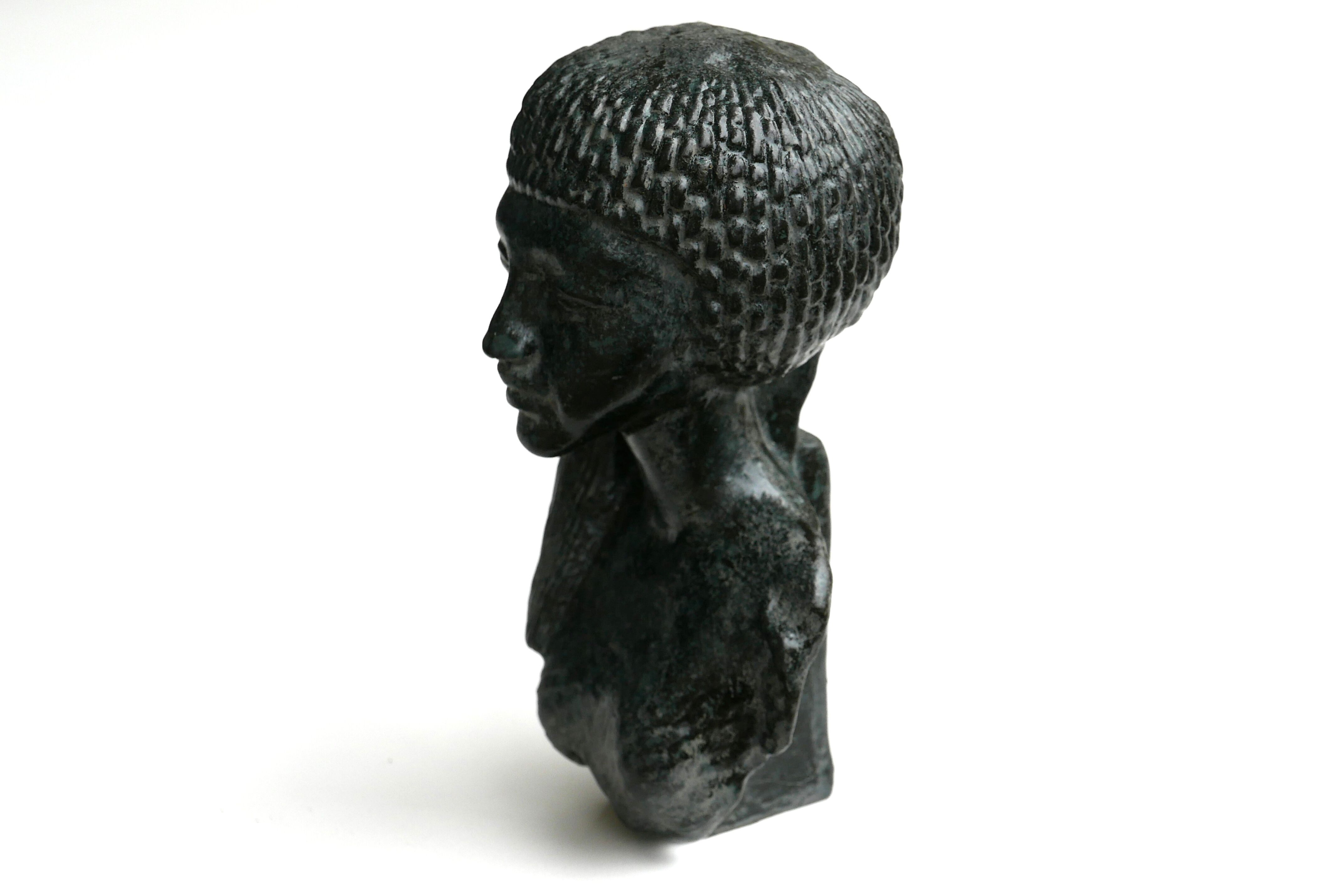 Woman bust in carved stone, 50s