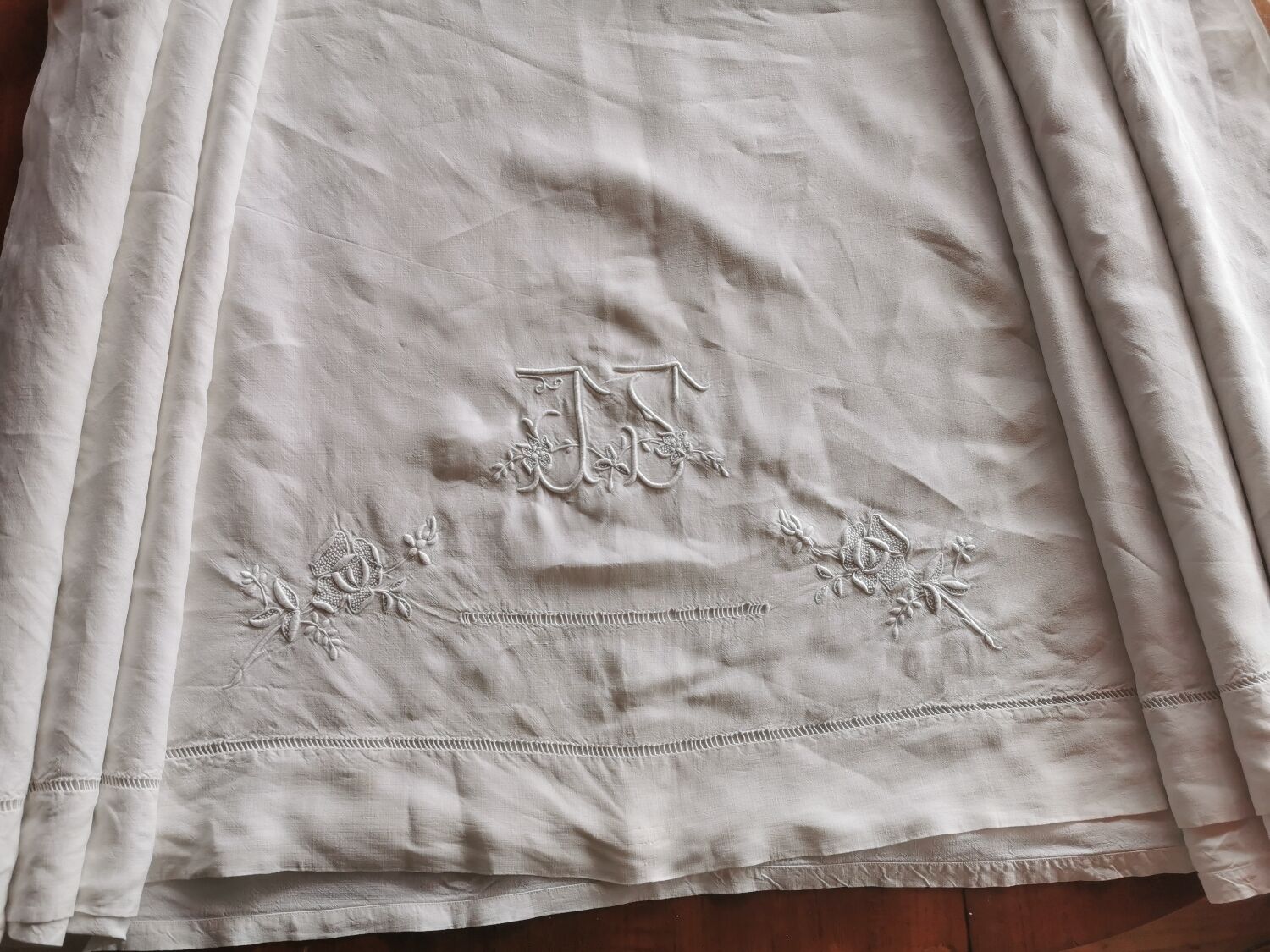 Antique embroidered linen sheet with a monogram.