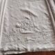 Antique embroidered linen sheet with a monogram.