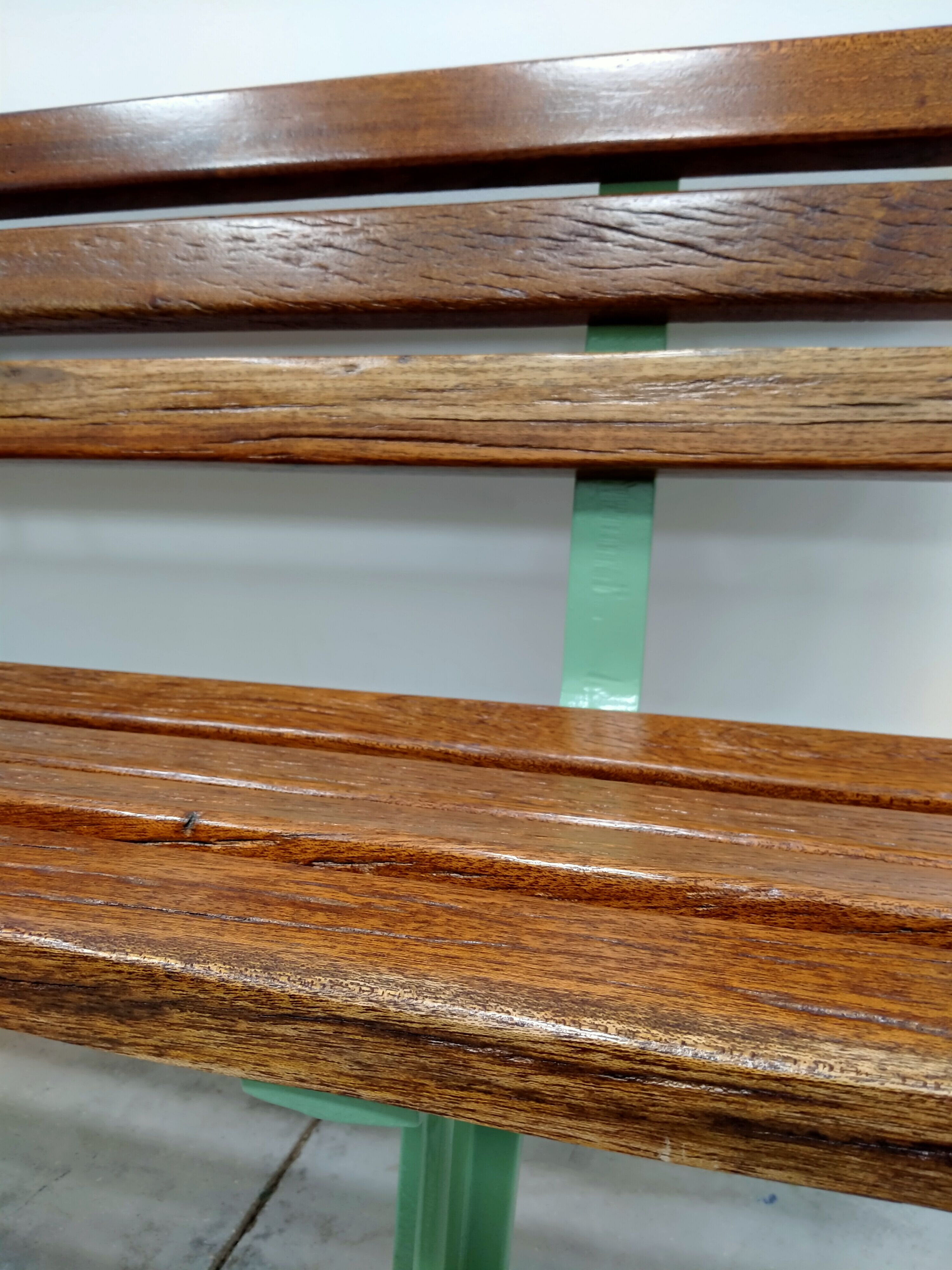 Restored and varnished garden bench in hardwood and olive green metal