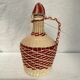 Dame jeanne bonbonne en plastique blanche et rouge dimension : hauteur -25 cm-