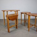 Restored Danish folding teak table with three nesting chairs by Poul Hundevad