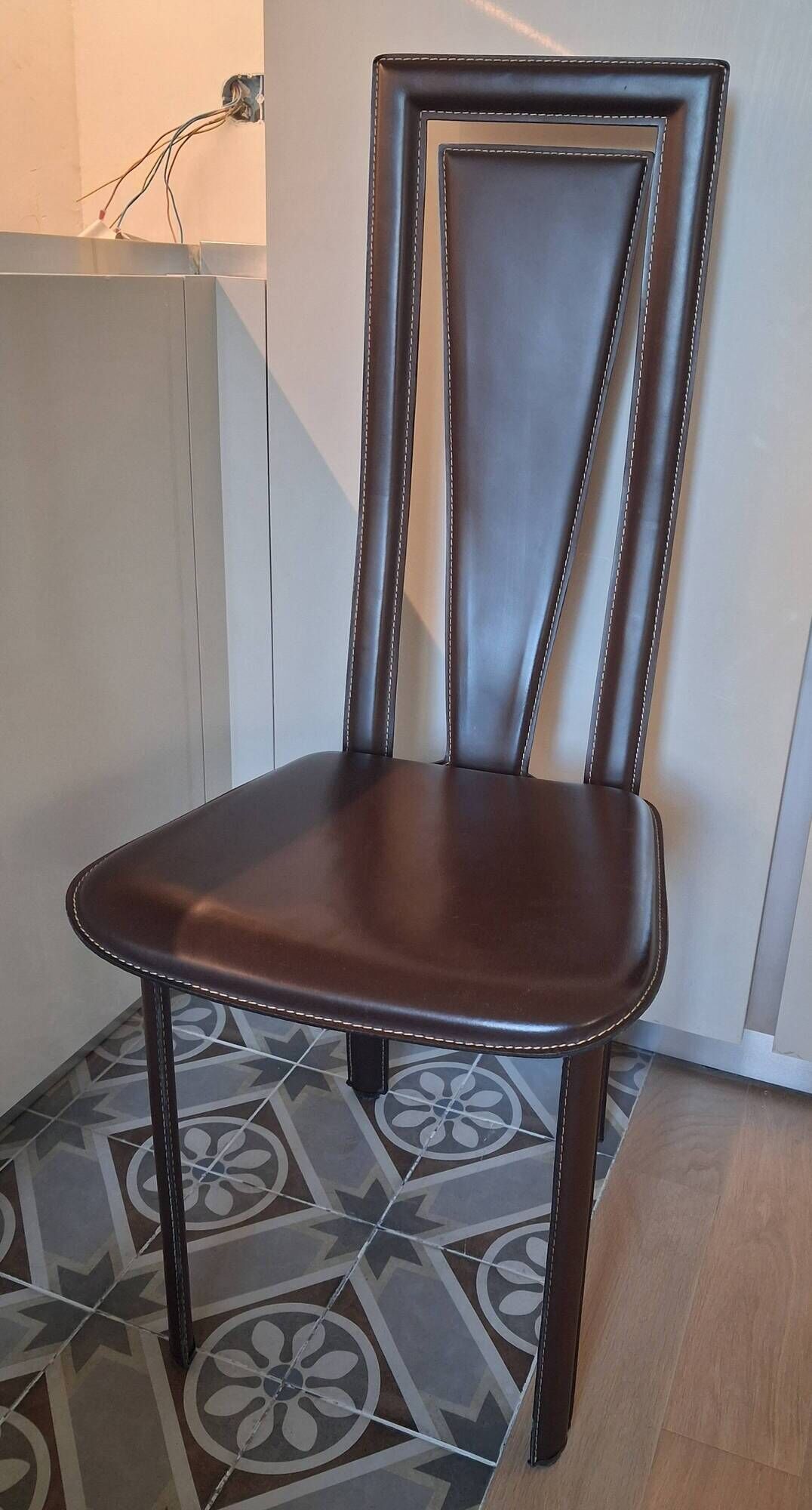 Set of 6 wooden chairs covered in leather.