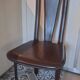 Set of 6 wooden chairs covered in leather.