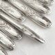 12 antique silver-plated knives with acanthus shell decoration and stainless steel blades.