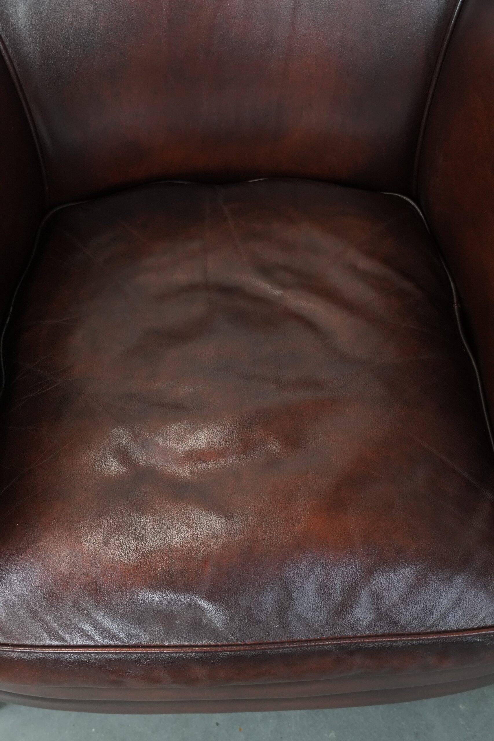 Set of two cow leather club armchairs in a luxurious red/brown colour