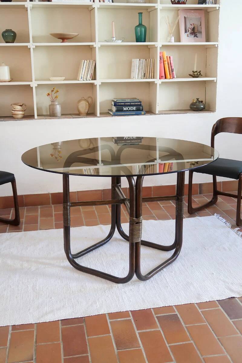 Round dining table in rattan, smoked glass top, 1970s.