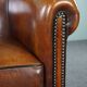 Club armchair in sheepskin with black piping