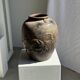 Large traditional Indonesian clay pot featuring a dragon.