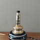Vintage 70s lamp base in black and gold metal.