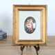 Vintage floral print with oval mat and gold wooden frame.