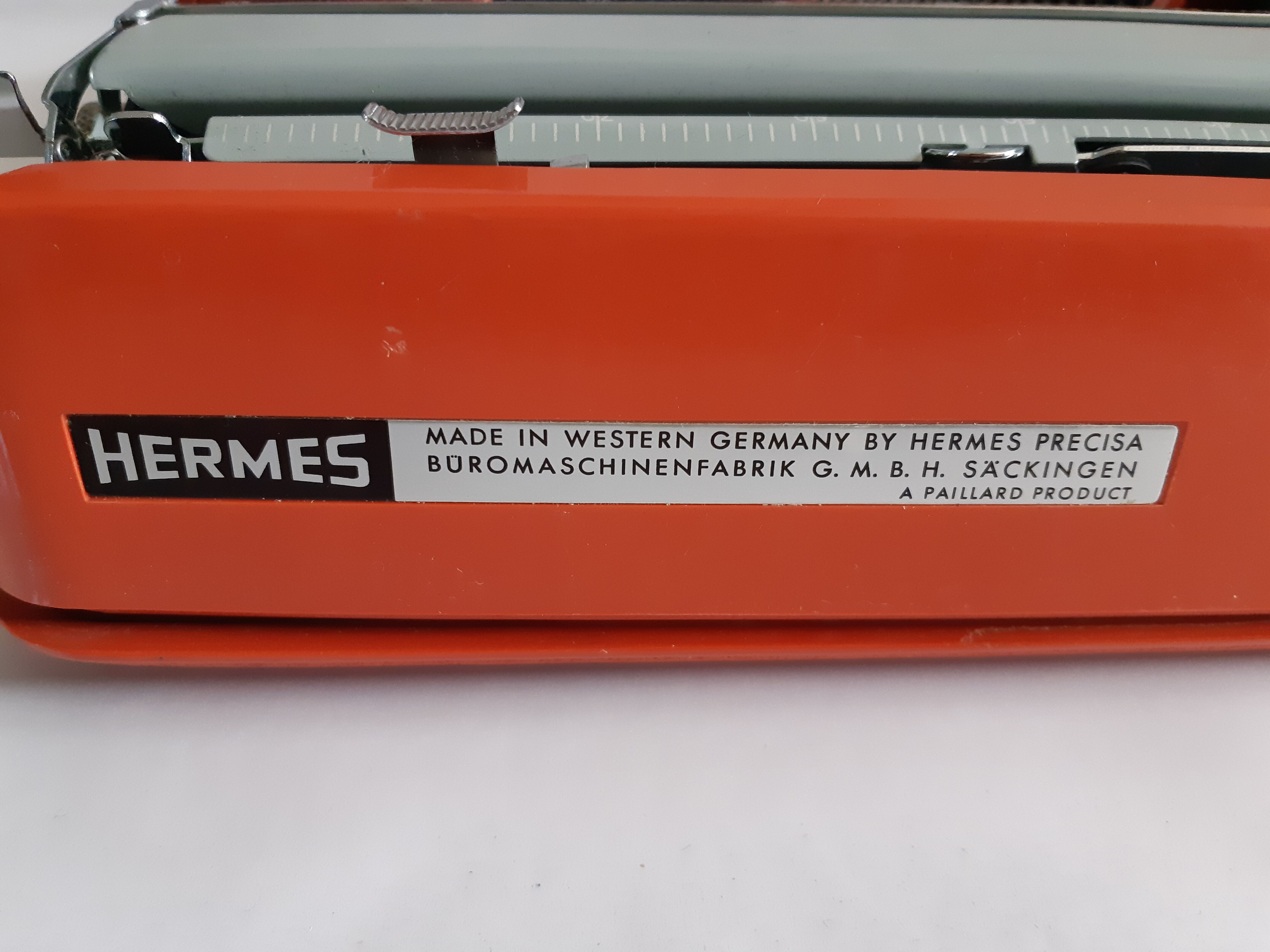 Hermes Baby orange typewriter, portable, functional