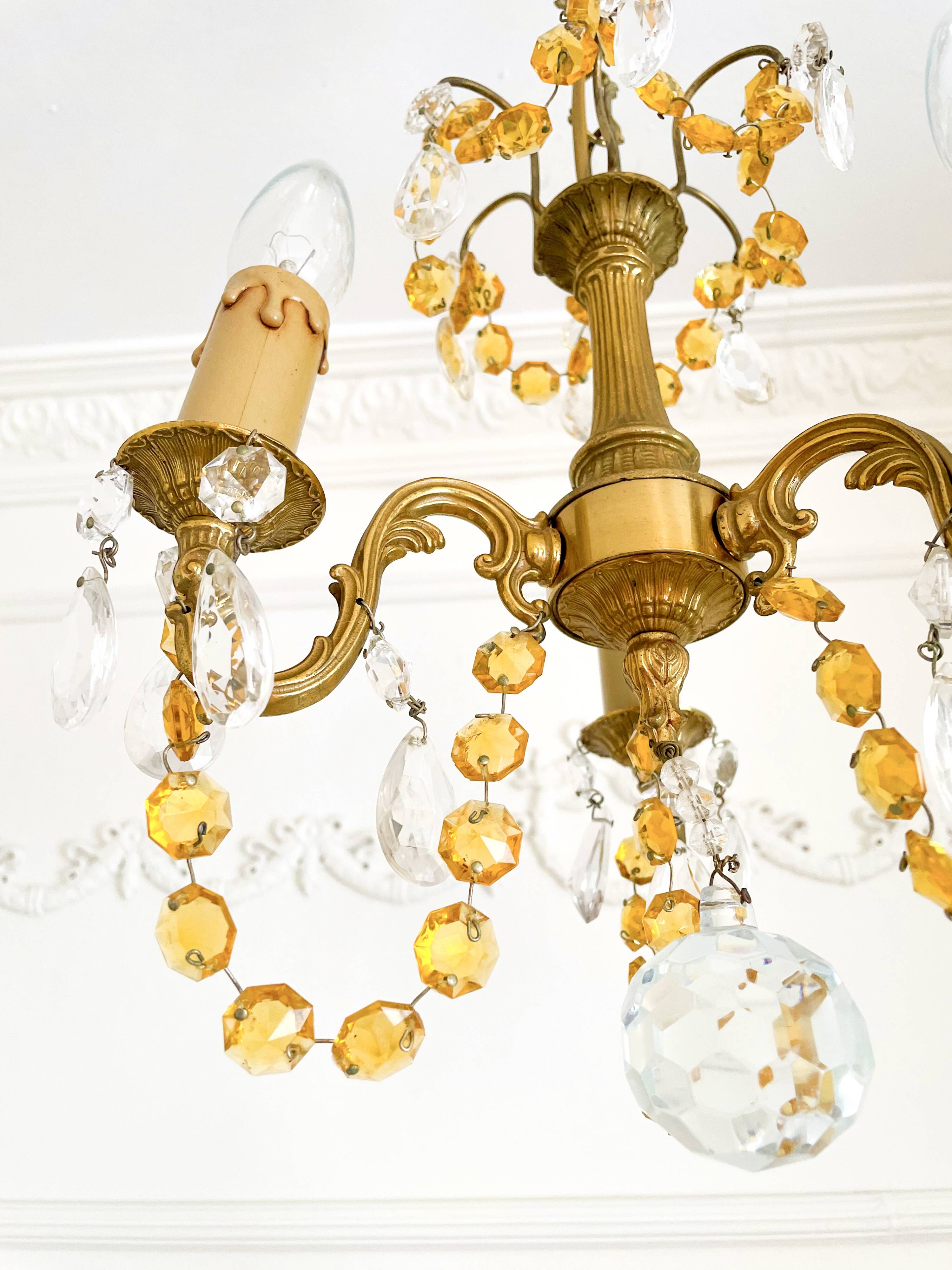 Small vintage brass chandelier with amber crystal pendants.