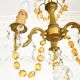 Small vintage brass chandelier with amber crystal pendants.