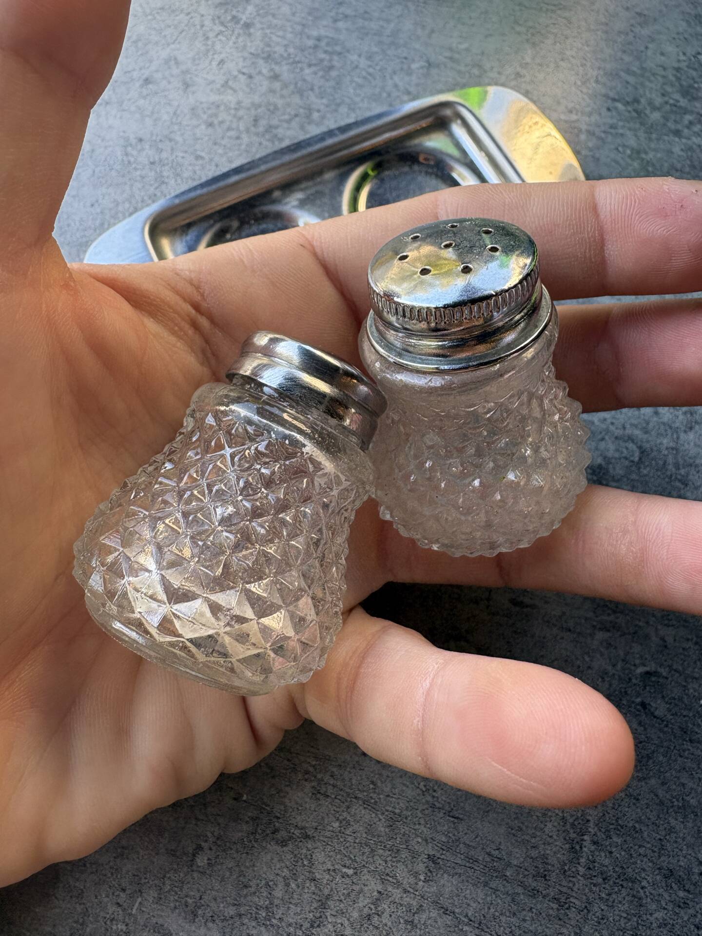 Vintage glass and chrome salt and pepper shaker set.