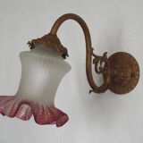 French Art Nouveau wall sconce in bronze with a white and pink glass shade.