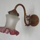 French Art Nouveau wall sconce in bronze with a white and pink glass shade.