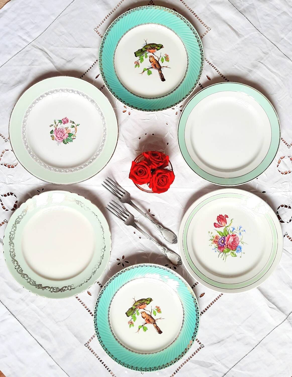 Old mismatched earthenware dinner plates accompanied by a deep dish