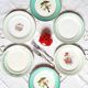 Old mismatched earthenware dinner plates accompanied by a deep dish