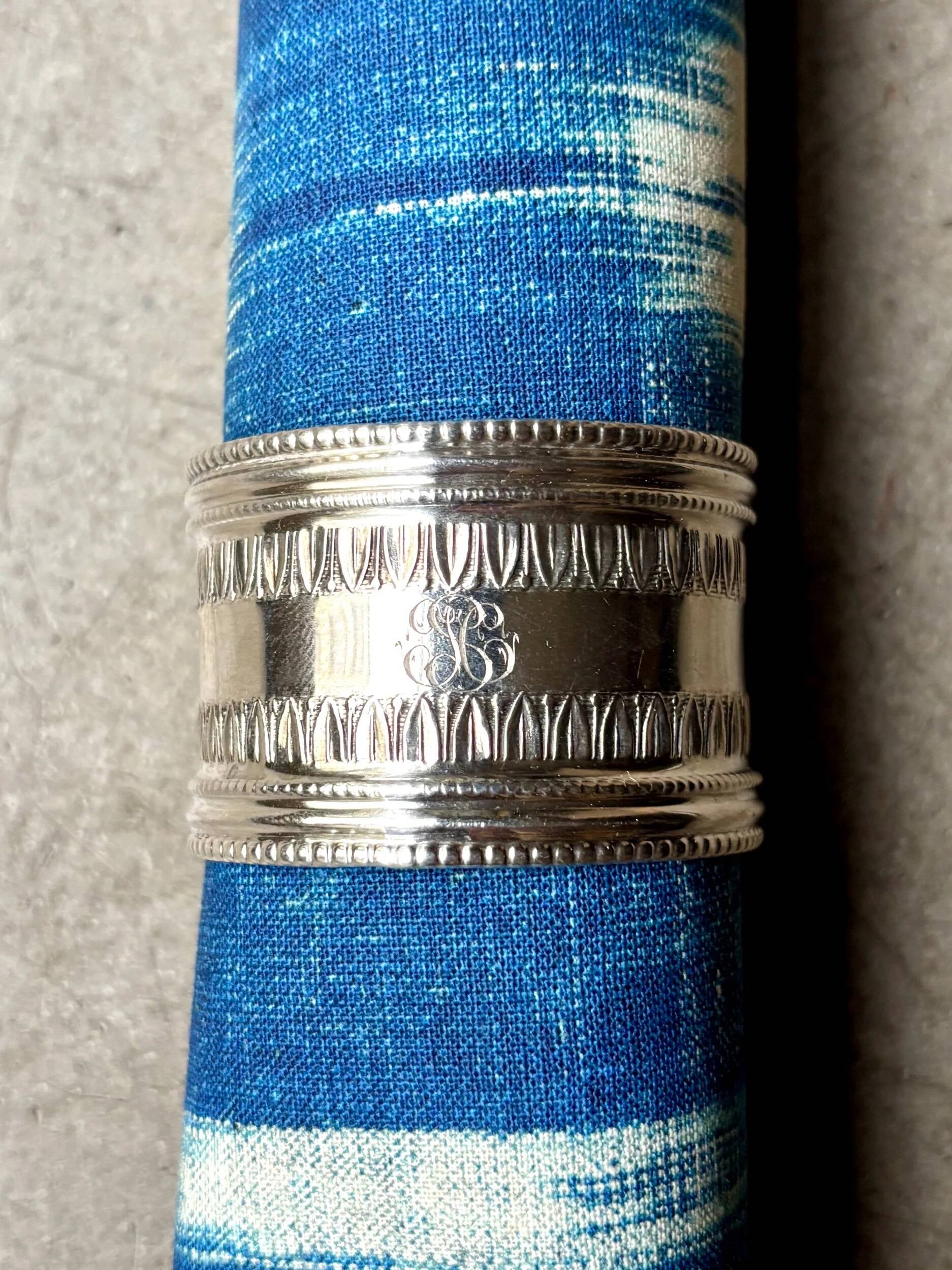 Monogrammed silver napkin ring with palmette and beaded motifs