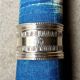 Monogrammed silver napkin ring with palmette and beaded motifs