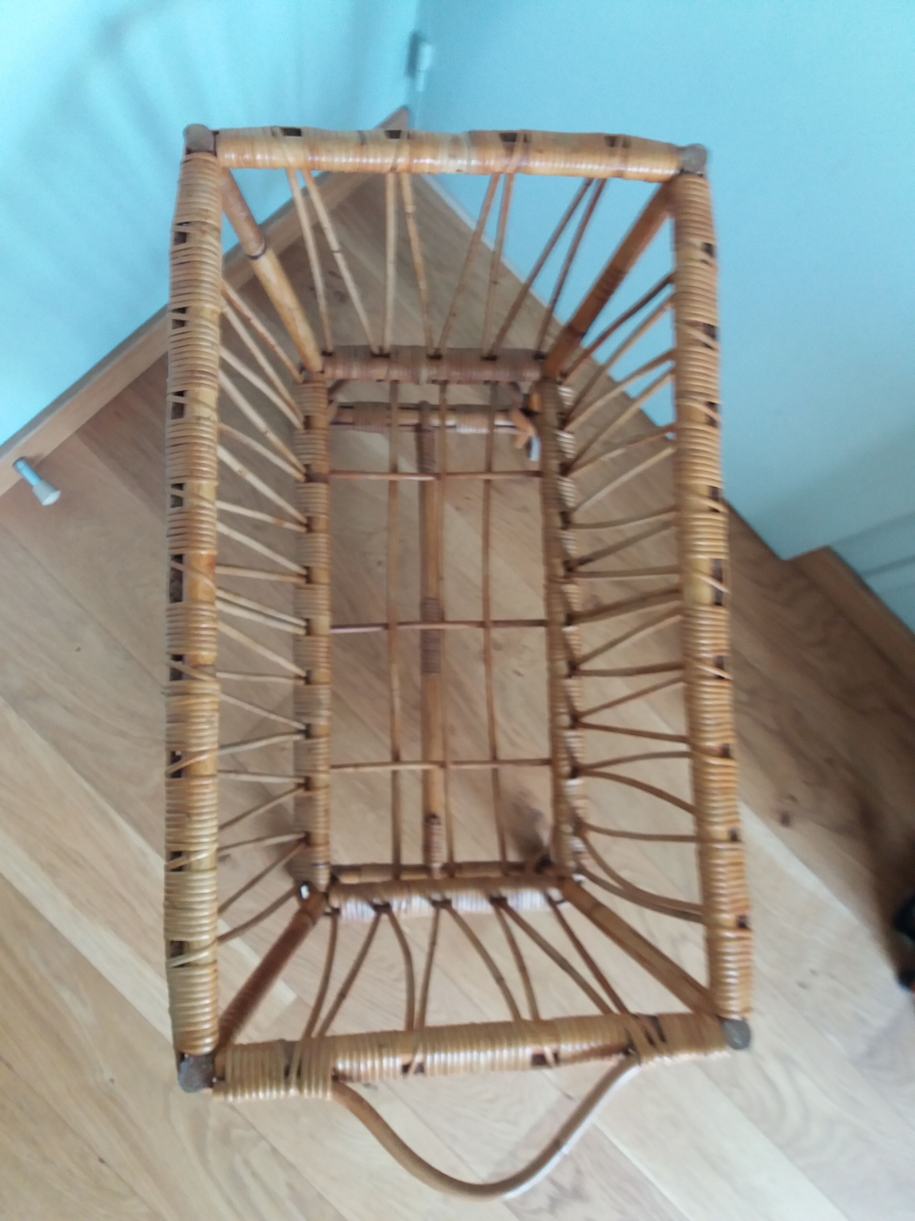 Rattan wicker cradle on wooden wheels