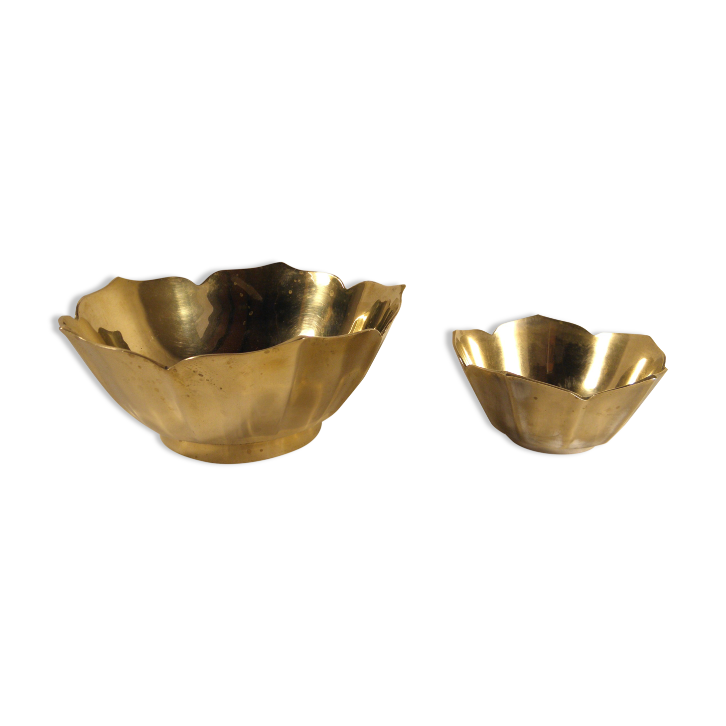 Two brass trundle cups