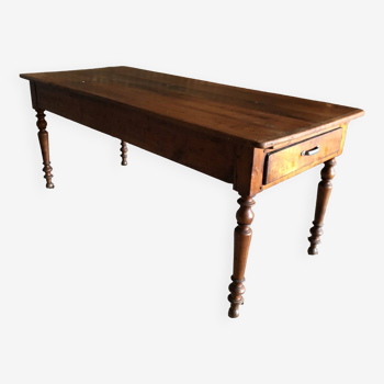 Antique Louis Philippe style farm table in solid cherry wood with turned base.