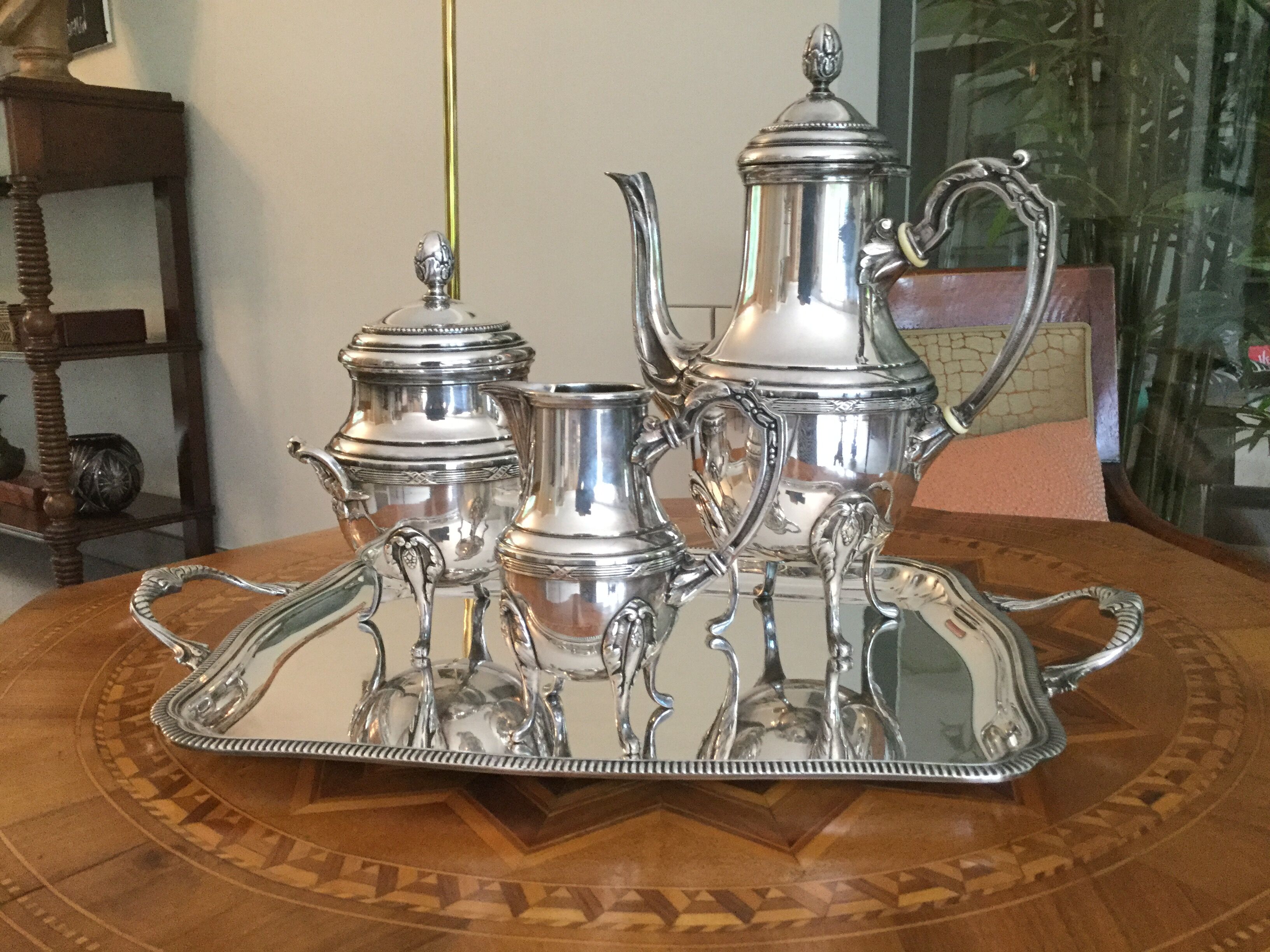 Set of a 4-piece silver metal coffee service
