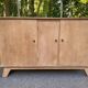 Vintage 1950s oak enfilade buffet with tapered legs.