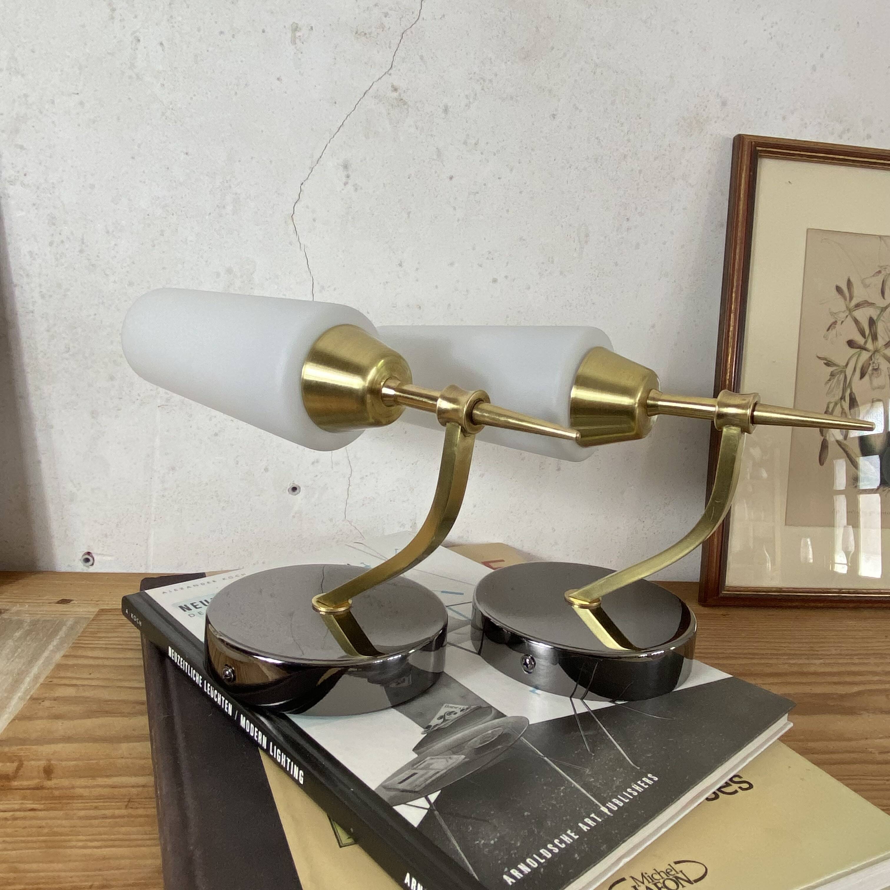 Pair of wall sconces in brass with white glass tulips.