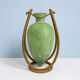 Rare glass paste amphora suspended in a wicker frame.