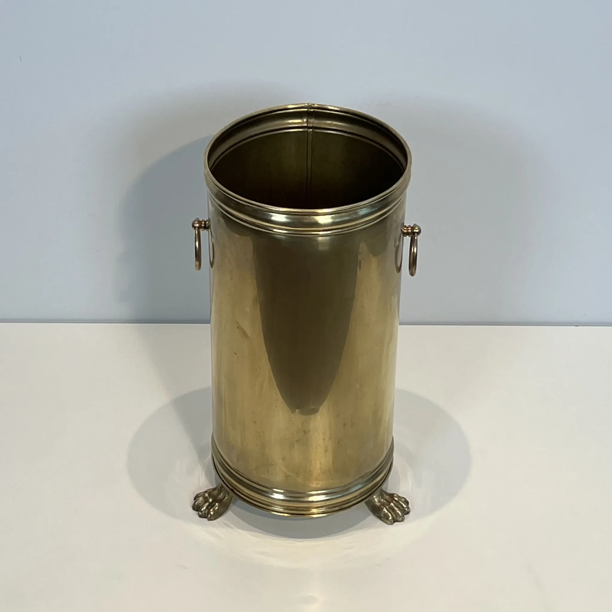 Cylindrical Brass Umbrella Stand with Ring Handles and Claw Feet.