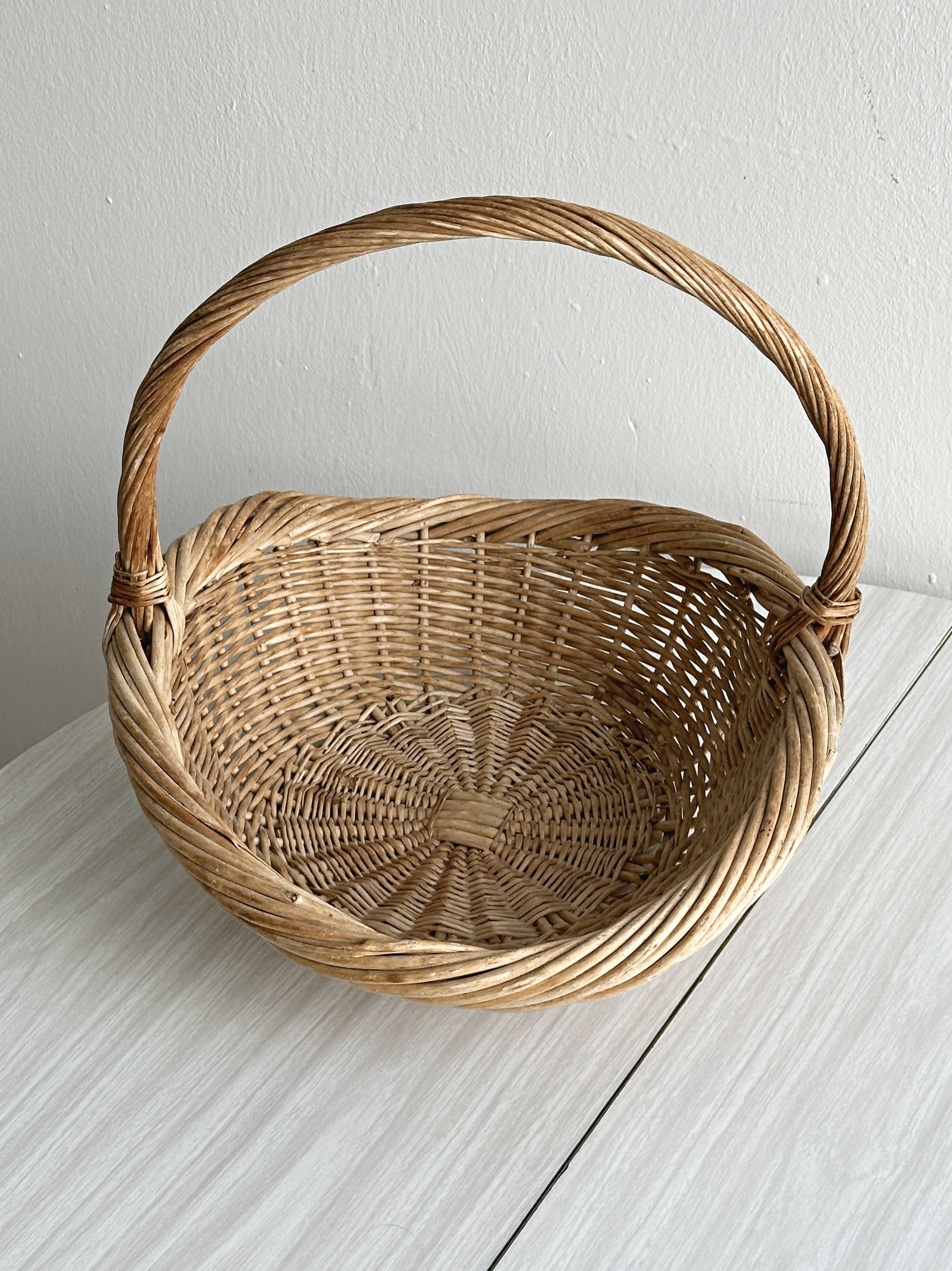 Large antique woven wicker basket with handle.